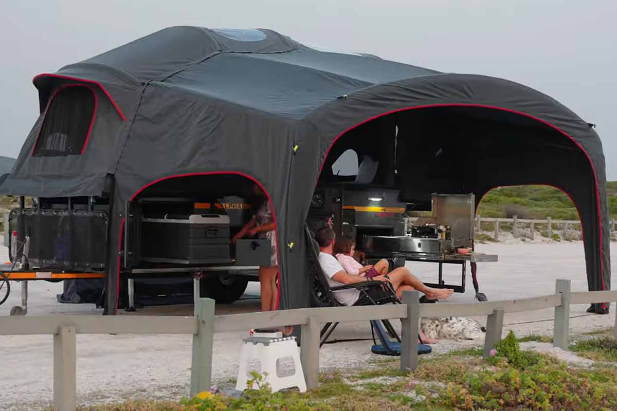 Une caravane luxueuse dotée d'une tente gonflable.