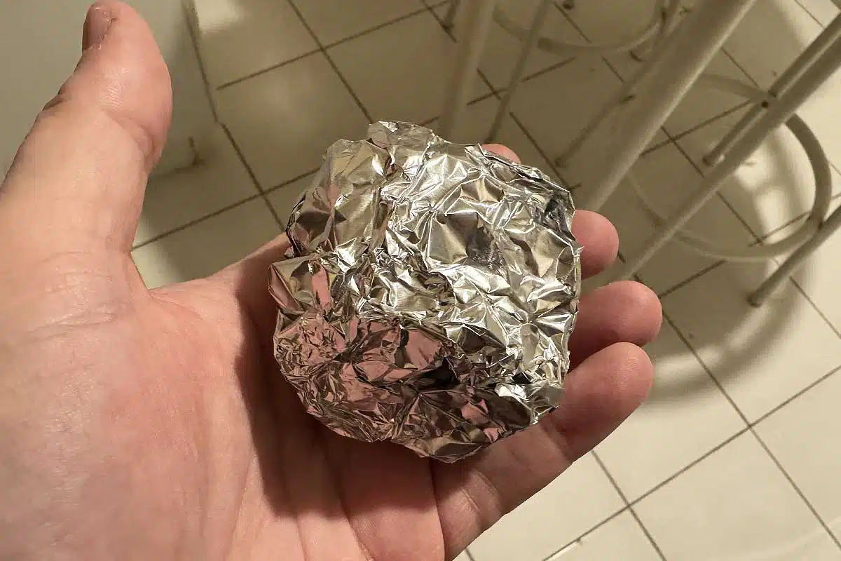 Une boule d'aluminium dans la main.