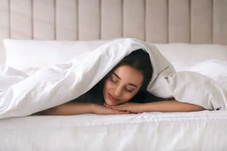 Une femme sous une couette.